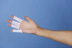 A person's hand with a bandage on it.