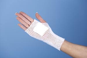 A woman's hand with a white glove on it.