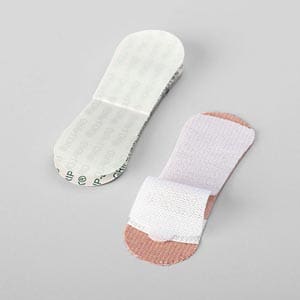 A pair of bandage pads on a white surface.