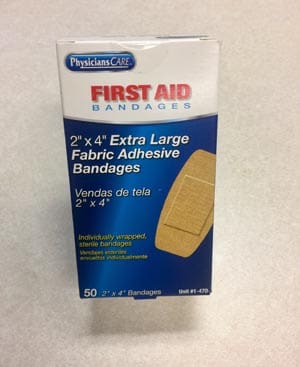 A box of first aid bandages on a table.