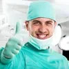 A surgeon giving a thumbs up in an operating room.